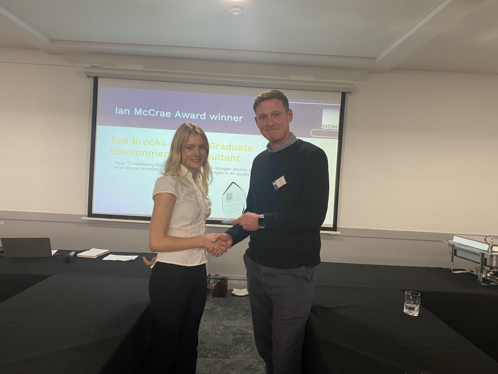 IAQM Chair Chris Rush presents 2025 Ian McCrae Award winner Eve Brooks-Parkin with her trophy