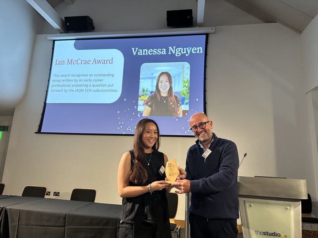 Vanessa is presented with the Ian McCrae Award trophy by Davide Pascarella.